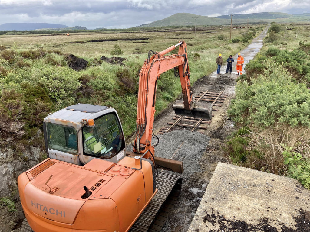 The excavator spreads some fine ballast